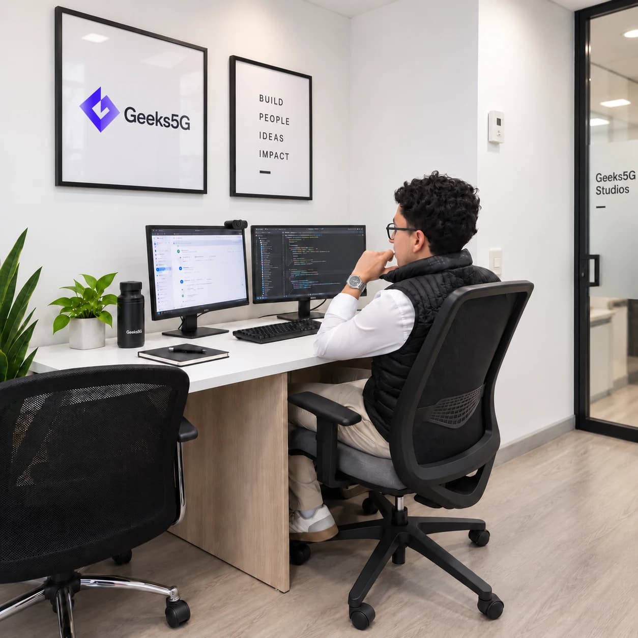 A Geeks5G Studios developer working across dual monitors