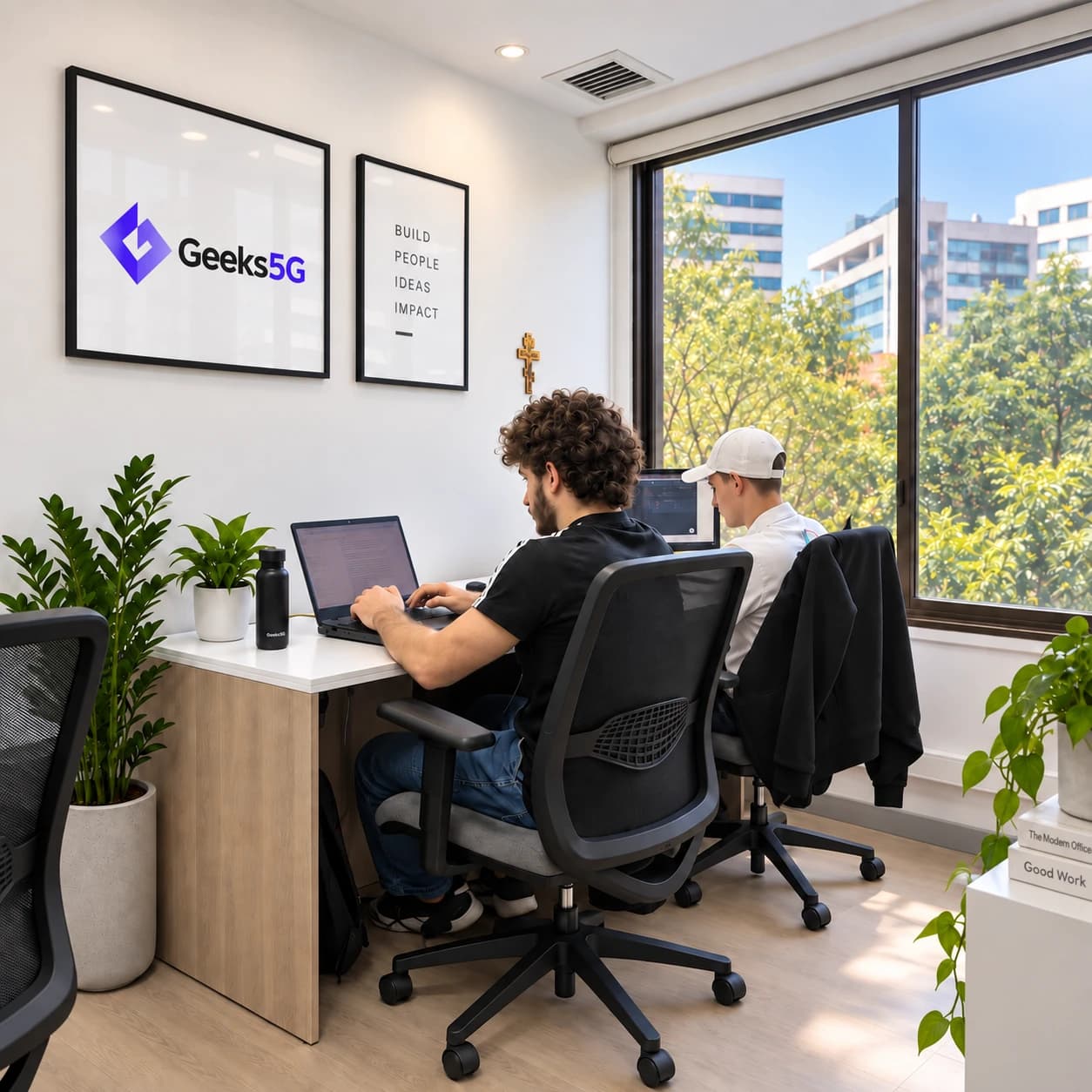 Two Geeks5G Studios teammates collaborating in the Geeks5G office